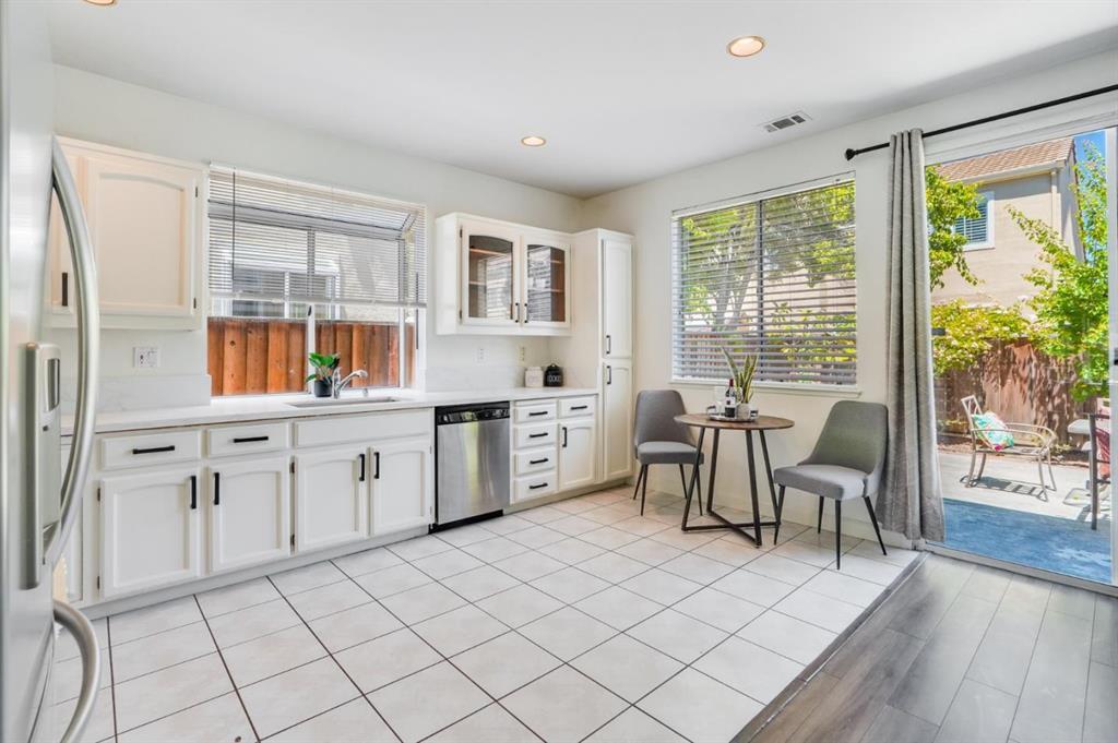 34372 Eucalyptus Terrace Fremont, CA 94555 - Photo 16 of 40 a kitchen with a sink cabinets and dining table chair
