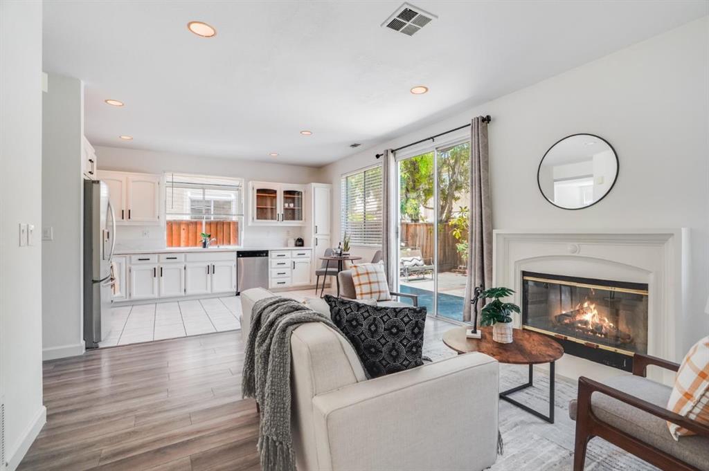 34372 Eucalyptus Terrace Fremont, CA 94555 - Photo 17 of 40 a living room with furniture a fireplace and a floor to ceiling window