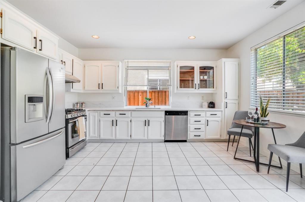 34372 Eucalyptus Terrace Fremont, CA 94555 - Photo 18 of 40 a kitchen with stainless steel appliances a refrigerator sink and cabinets