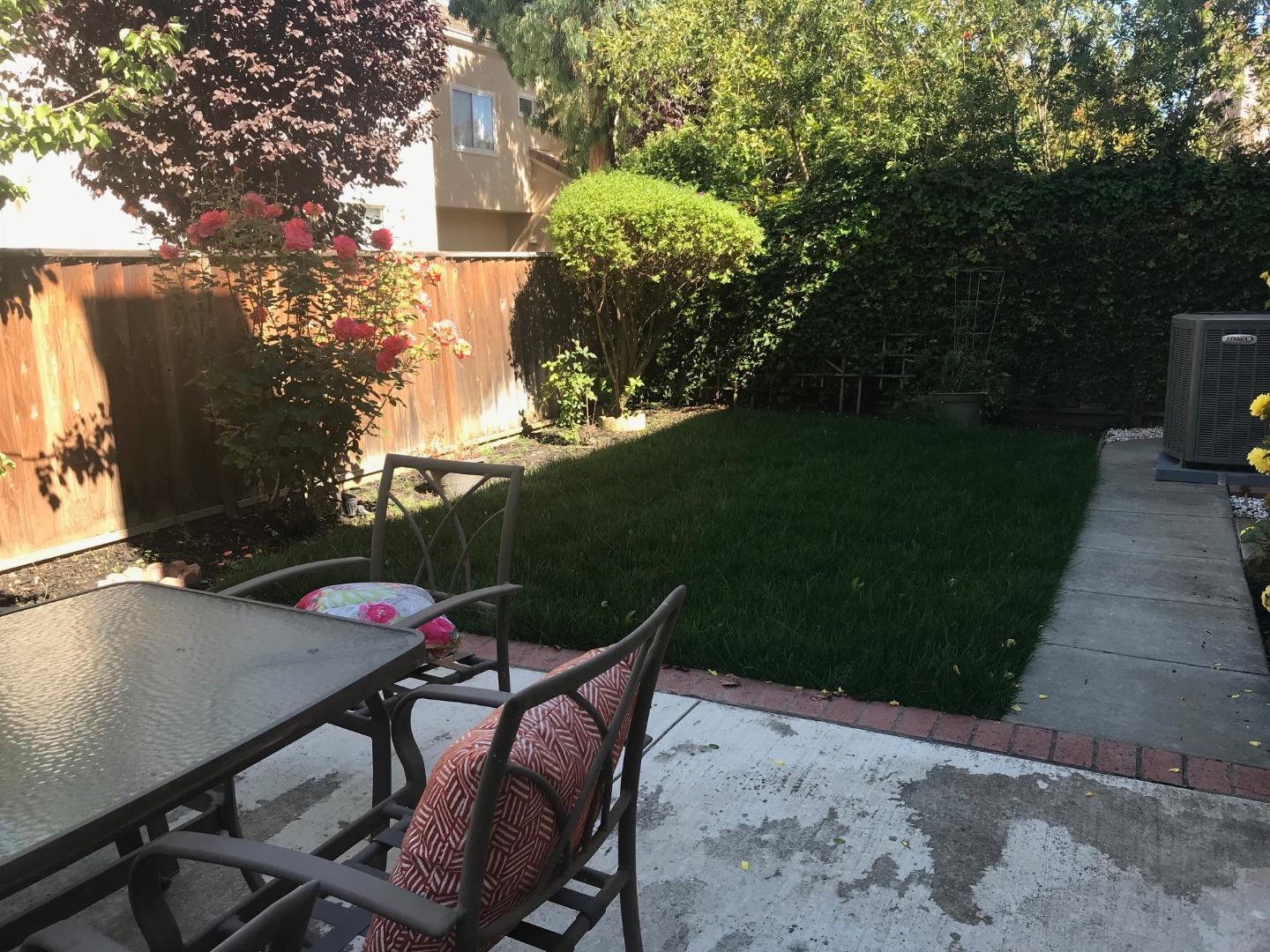 34372 Eucalyptus Terrace Fremont, CA 94555 - Photo 20 of 40 a backyard of a house with table and chairs plants and large trees