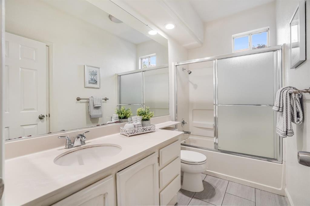34372 Eucalyptus Terrace Fremont, CA 94555 - Photo 21 of 40 a bathroom with a granite countertop sink toilet a large mirror a shower and