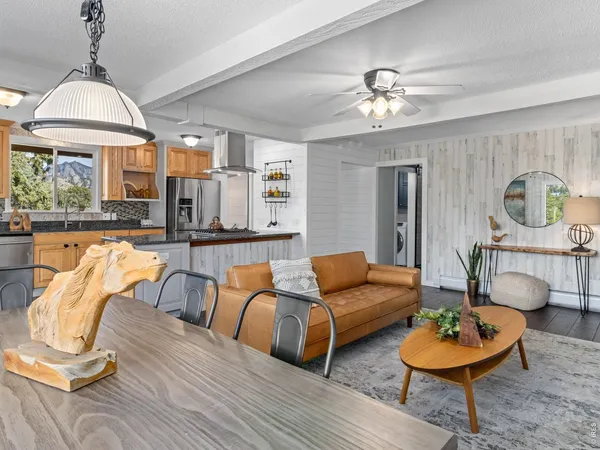 a living room with furniture and a chandelier