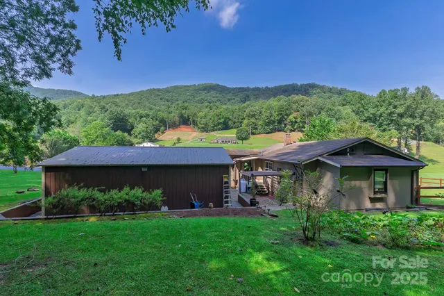 a kitchen with stainless steel appliances granite countertop white cabinets and window