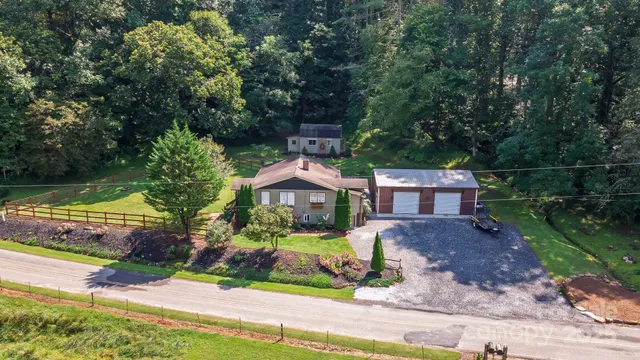 a front view of a house with a garden and yard