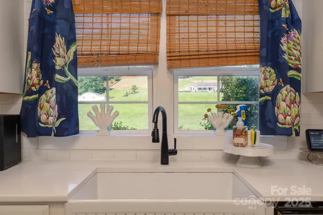 a kitchen with granite countertop a refrigerator and cabinets