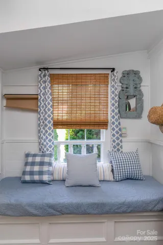 a kitchen with granite countertop a sink cabinets stainless steel appliances and a window