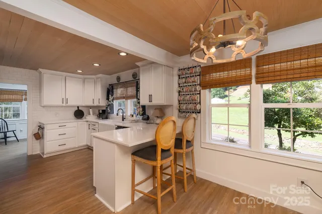 a kitchen with stainless steel appliances kitchen island granite countertop a refrigerator and a stove