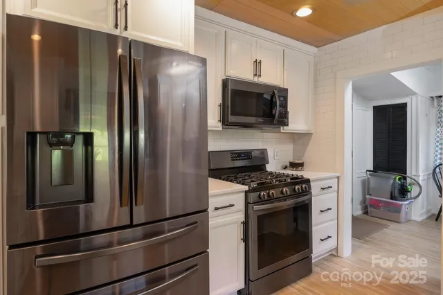 a view of a room with furniture and wooden floor