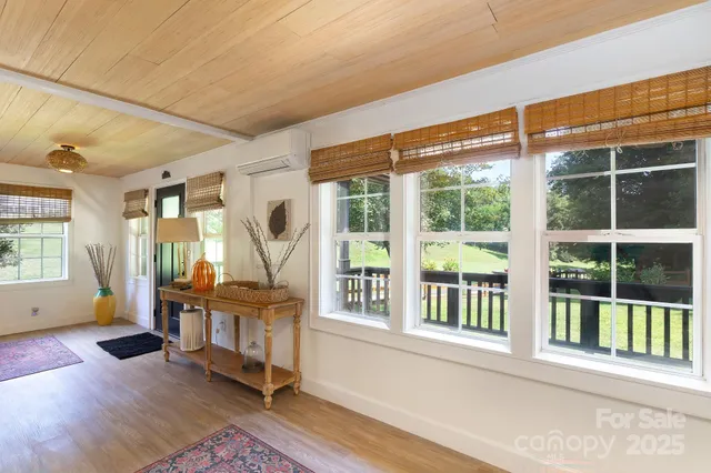 a front view of a house with wooden floor and windows