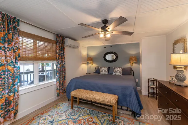 a living room with a couch and dresser with wooden floor