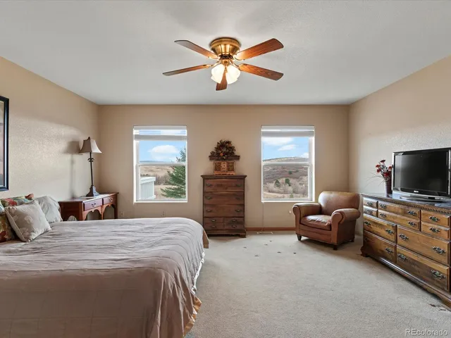 a spacious bedroom with a bed and glass door