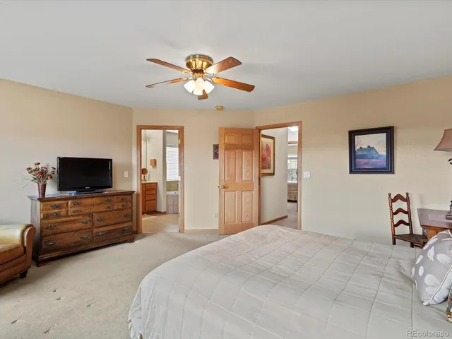 a bedroom with a bed and a couch