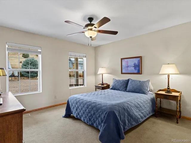 a bed room with furniture and a potted plant