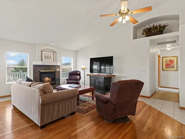 a kitchen with stainless steel appliances granite countertop a stove a sink a microwave a dining table and chairs with wooden floor