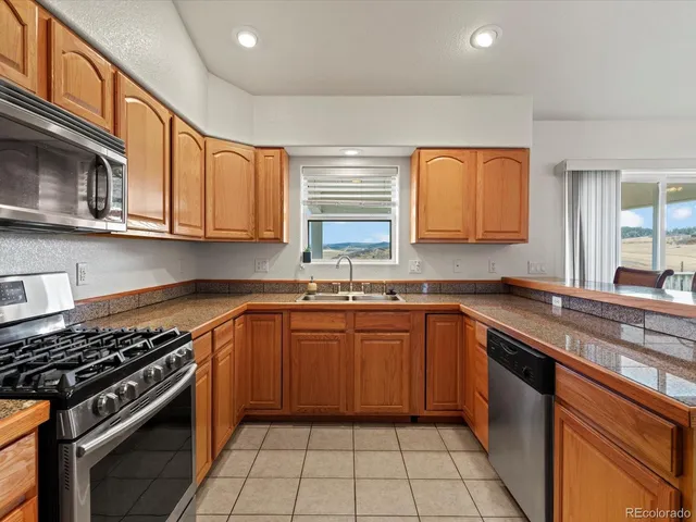 a bathroom with a tub a double vanity sink and mirror