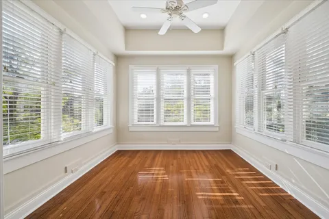 a view of empty room with wooden floor
