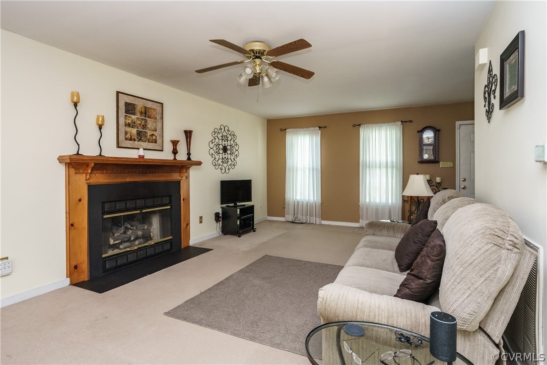 7525 Genuine Risk Lane Midlothian, VA 23112 - Photo 3 of 26 a living room with furniture and a fireplace