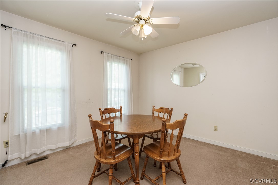 7525 Genuine Risk Lane Midlothian, VA 23112 - Photo 6 of 26 a view of a dining room with furniture and a chandelier