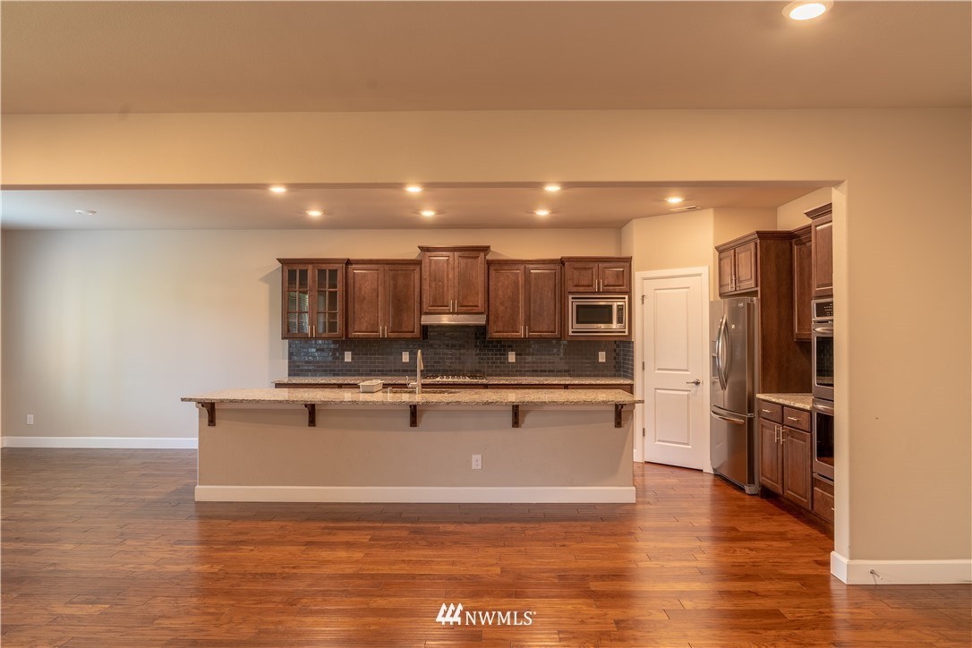 17317 40th Avenue Southeast Bothell, WA 98012 - Photo 4 of 24 a view of kitchen with stainless steel appliances granite countertop refrigerator sink and stove