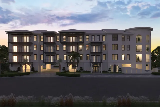 a view of building with lot of cars parked in front of it