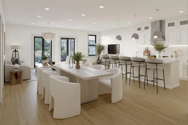 a view of living room kitchen with stainless steel appliances granite countertop lots of counter top space and furniture