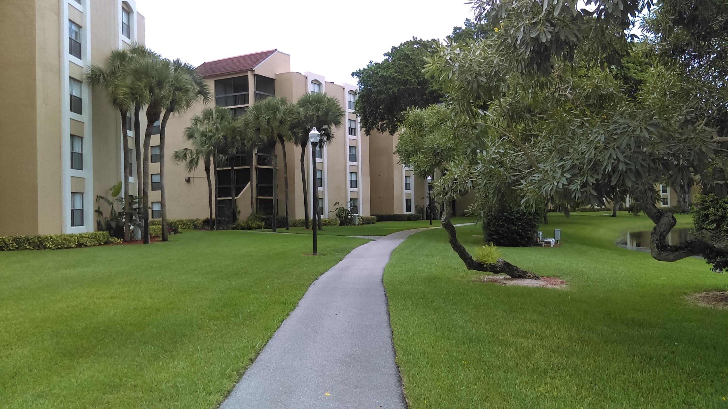 820 Lavers Circle, Unit G402 Delray Beach, FL 33444 - Photo 17 of 23 path around lake