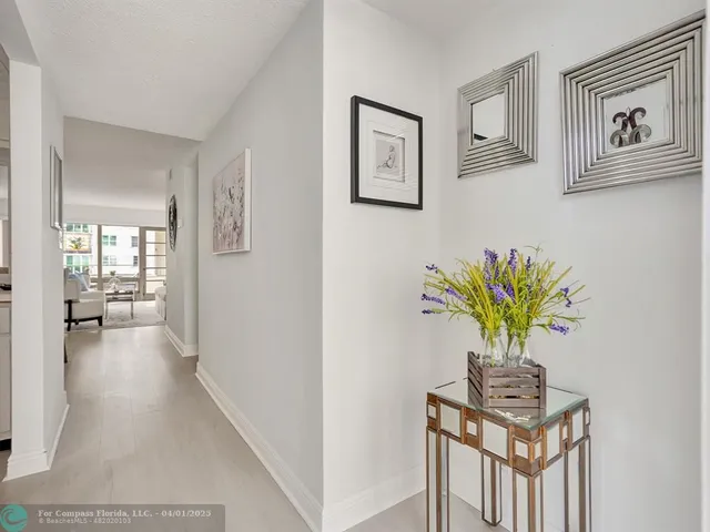 a view of a hallway to a livingroom with furniture