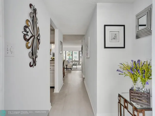 a view of a hallway with paintings on the wall
