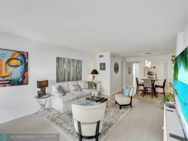 a living room with fireplace furniture and a table
