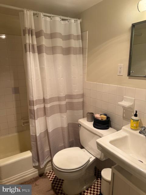 224 West Rittenhouse Square, Unit 1417 Philadelphia, PA 19103 - Photo 12 of 14 a white toilet sitting next to a bathroom sink and a shower