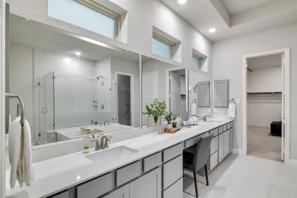 a bathroom with a double vanity sink a mirror and a shower