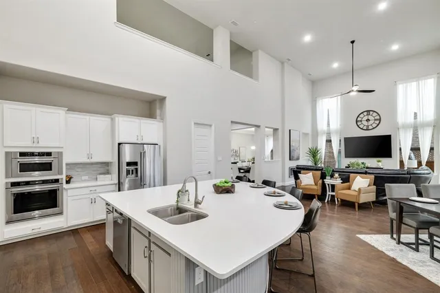 a large kitchen with a table and chairs