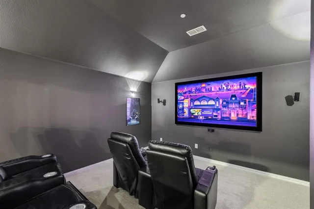 a room with furniture projector and screen