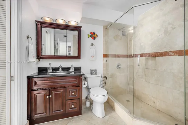 a bathroom with a toilet a sink and shower
