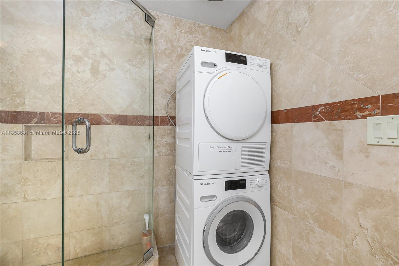 345 Ocean Drive, Unit 211 Miami Beach, FL 33139 - Photo 15 of 27 a utility room with dryer and washer