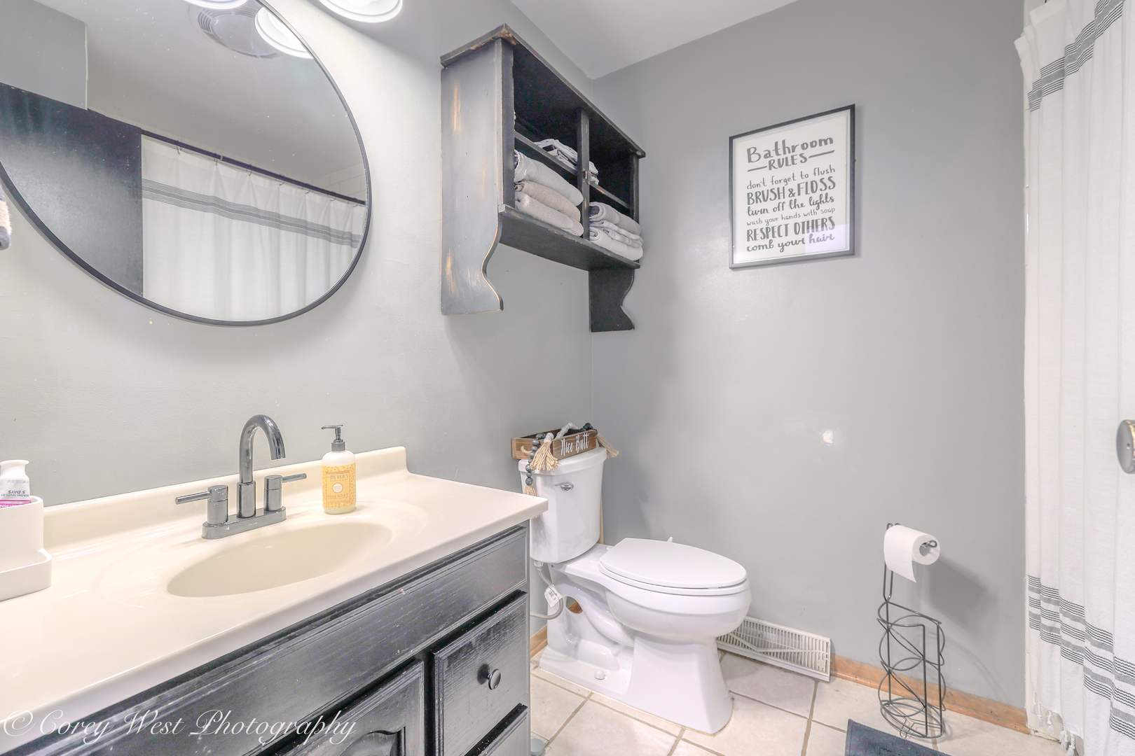 1811 South 7th Street DeKalb, IL 60115 - Photo 23 of 36 a bathroom with a toilet a sink and mirror