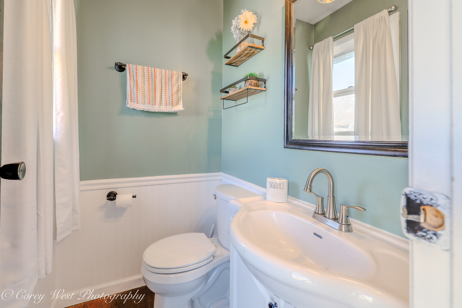 1811 South 7th Street DeKalb, IL 60115 - Photo 25 of 36 a bathroom with a toilet sink and mirror