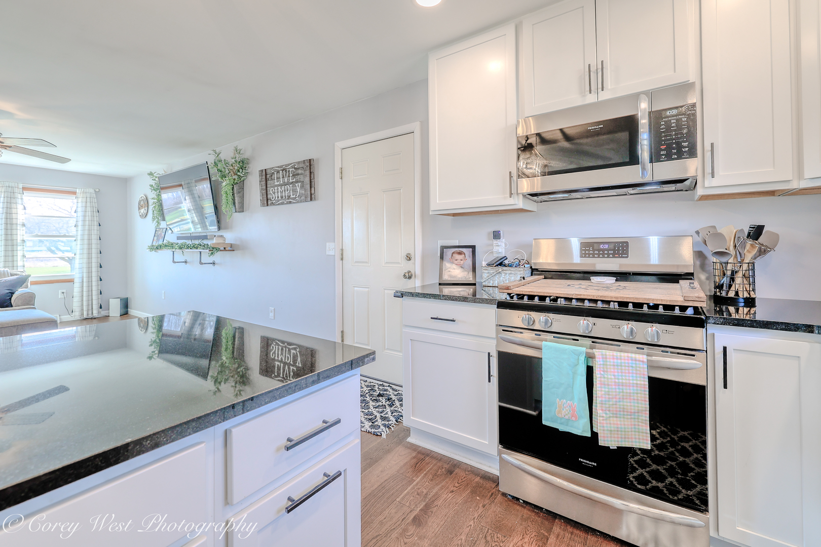 1811 South 7th Street DeKalb, IL 60115 - Photo 9 of 36 a kitchen with stainless steel appliances granite countertop a stove a sink and a microwave