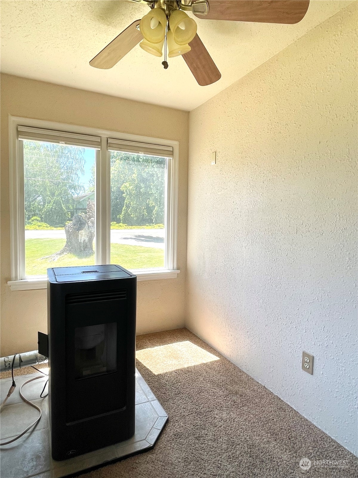 47 Kermel Road Omak, WA 98841 - Photo 13 of 40 a living room with a fireplace windows and a table