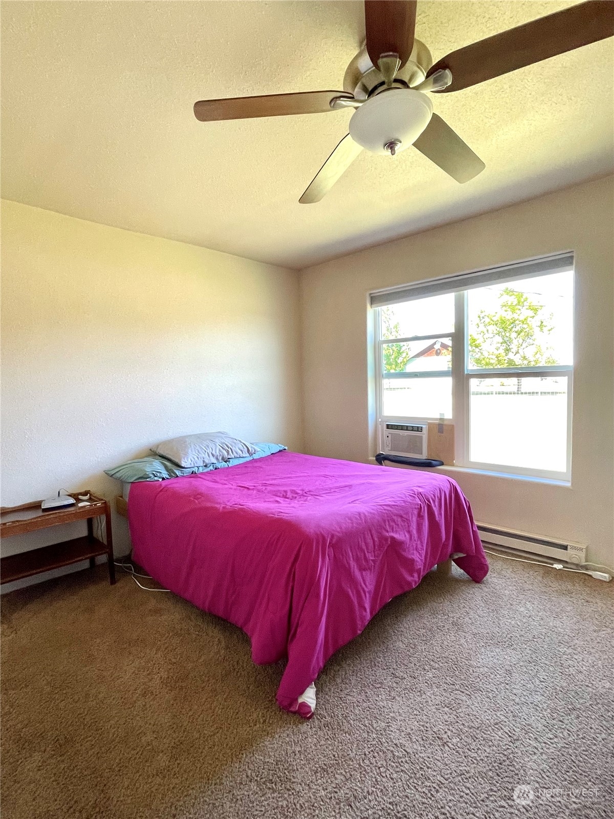 47 Kermel Road Omak, WA 98841 - Photo 15 of 40 a spacious bedroom with a bed and a chandelier