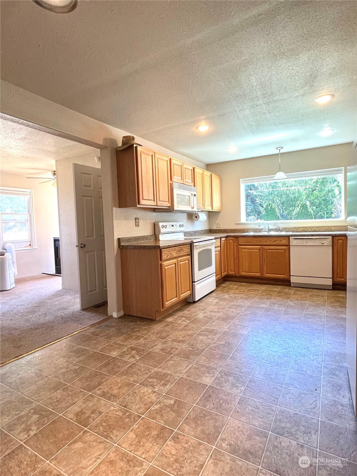 47 Kermel Road Omak, WA 98841 - Photo 6 of 40 a large kitchen with kitchen island a sink stove and refrigerator