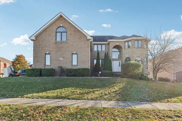 a front view of a house with a yard and garage