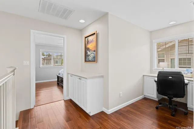a workspace with wooden floor and a window