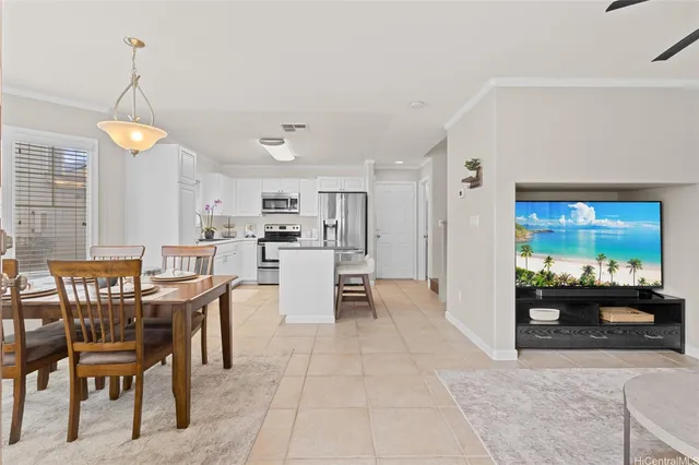 a view of kitchen with refrigerator stove dining table and chairs