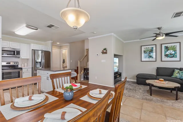 a living room with furniture and a dining table