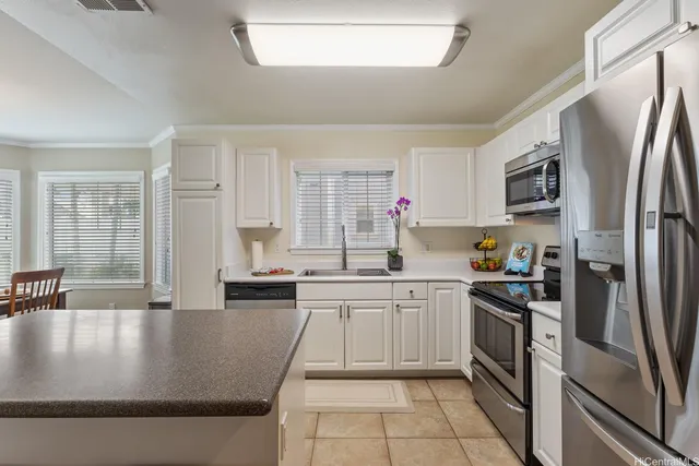 a kitchen with stainless steel appliances granite countertop a sink a stove and a refrigerator