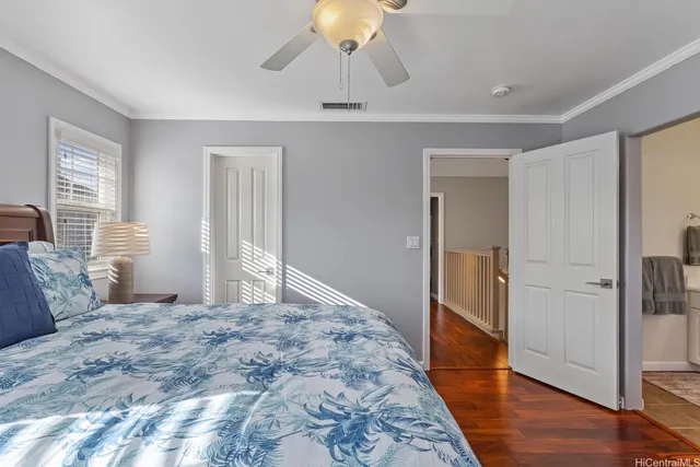 a large bedroom with a bed and wooden floor