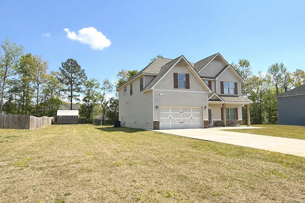 33 Sugar Maple Drive Fort Mitchell, AL 36856 - Photo 2 of 29 a front view of a house with a yard and garage