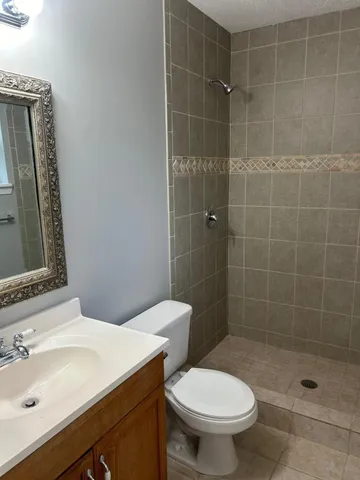 a bathroom with a sink toilet and shower