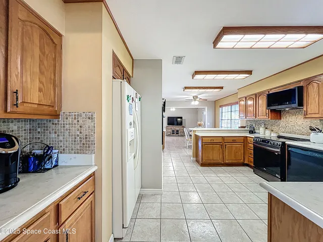 a spacious bedroom with a bed and a chandelier
